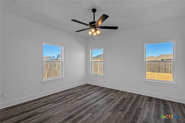 unfurnished room with dark hardwood / wood-style flooring, a wealth of natural light, and ceiling fan