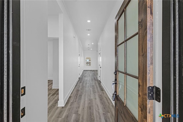 corridor with light hardwood / wood-style flooring