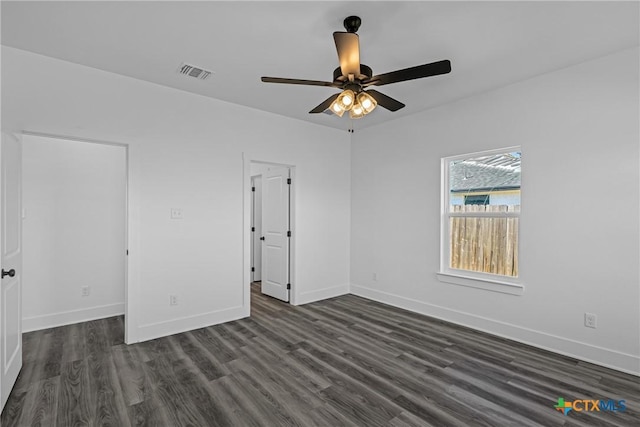 empty room featuring ceiling fan and dark hardwood / wood-style flooring