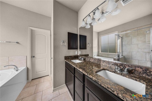 4703 Prewitt Ranch Rd, Killeen, TX 76549 - bathroom with a bath, double vanity, a shower stall, tile patterned flooring, and baseboards