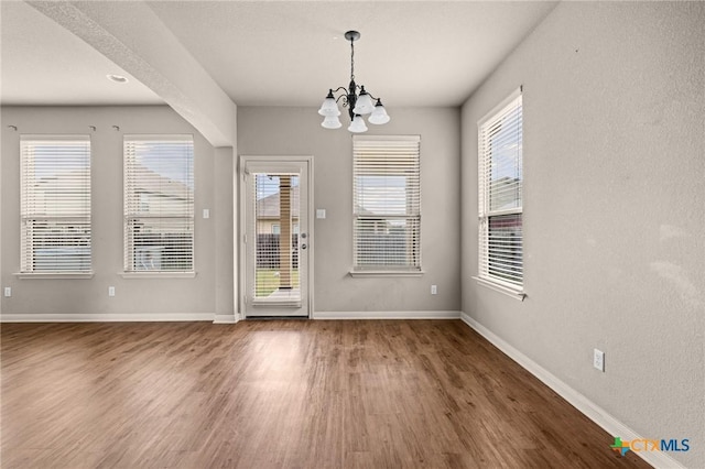 4703 Prewitt Ranch Rd, Killeen, TX 76549 - unfurnished dining area with a chandelier, wood finished floors, and baseboards