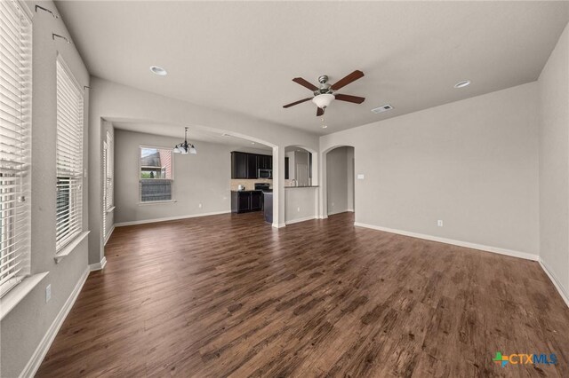4703 Prewitt Ranch Rd, Killeen, TX 76549 - unfurnished living room featuring a ceiling fan, arched walkways, dark wood-style flooring, baseboards, and recessed lighting