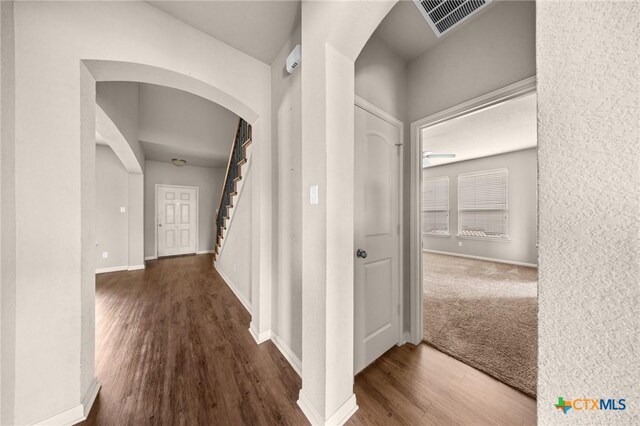 4703 Prewitt Ranch Rd, Killeen, TX 76549 - hallway featuring arched walkways, wood finished floors, stairway, and baseboards