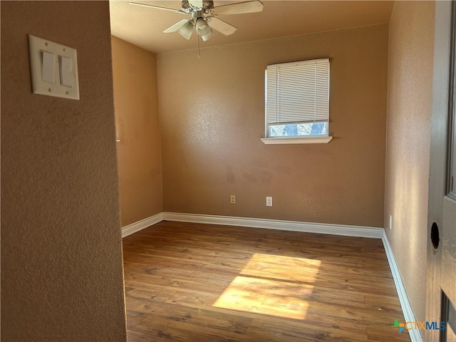 empty room featuring ceiling fan and light hardwood / wood-style floors