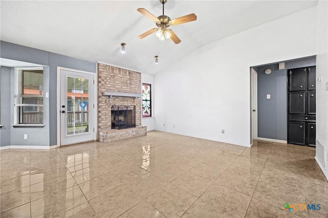 4818 Bramblewood Dr, Killeen, TX 76542 - unfurnished living room with vaulted ceiling, a ceiling fan, tile patterned floors, and a brick fireplace
