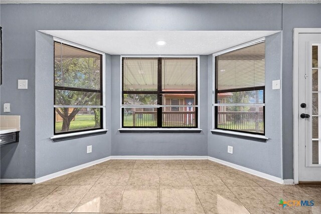 4818 Bramblewood Dr, Killeen, TX 76542 - unfurnished dining area with healthy amount of natural light and tile patterned floors