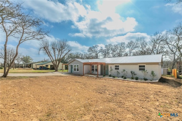 ranch-style house with metal roof