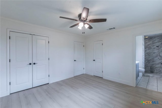 unfurnished bedroom featuring baseboards, light wood-style flooring, and crown molding