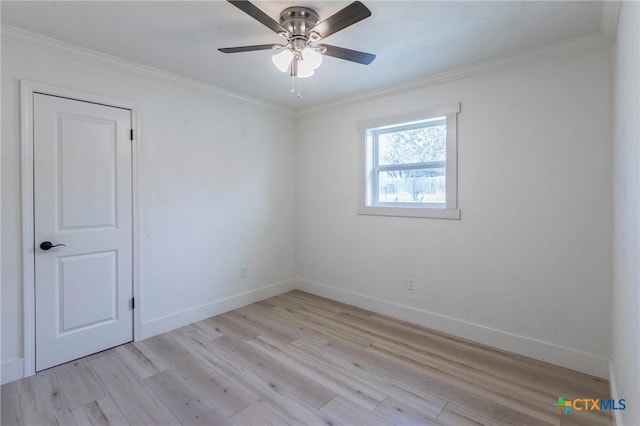 empty room featuring ornamental molding, baseboards, ceiling fan, and light wood finished floors