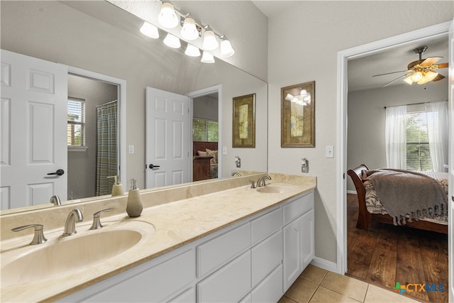 bathroom with hardwood / wood-style floors, vanity, and ceiling fan