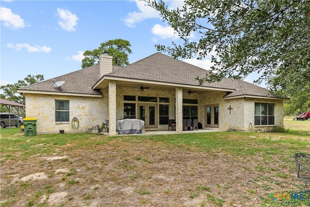 rear view of property featuring ceiling fan, a yard, and a patio area