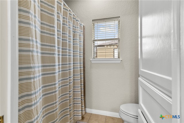 bathroom featuring tile patterned floors and toilet