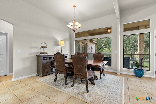 dining space featuring lofted ceiling, light tile patterned floors, and a notable chandelier