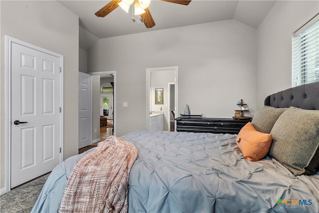 bedroom with ensuite bath, lofted ceiling, and ceiling fan