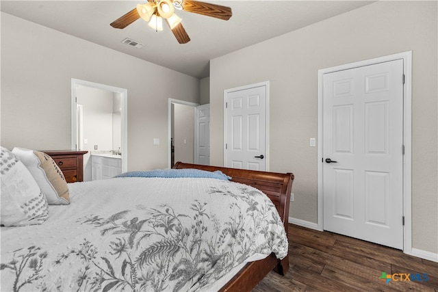 bedroom with dark wood-type flooring, ceiling fan, and connected bathroom