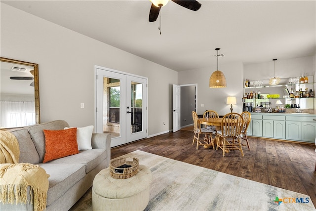 living room featuring dark wood-type flooring, ceiling fan, and french doors