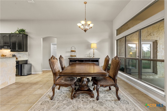 dining space featuring a notable chandelier and light tile patterned floors