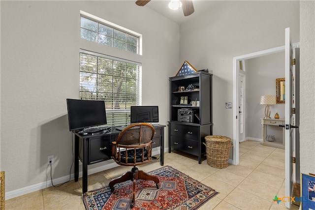 tiled office space featuring ceiling fan