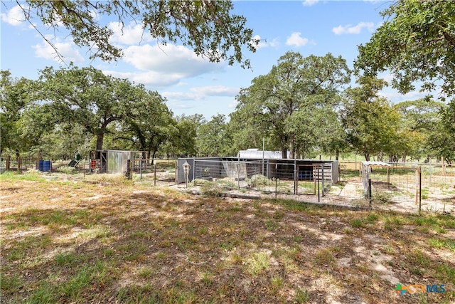 view of yard featuring an outdoor structure and a rural view