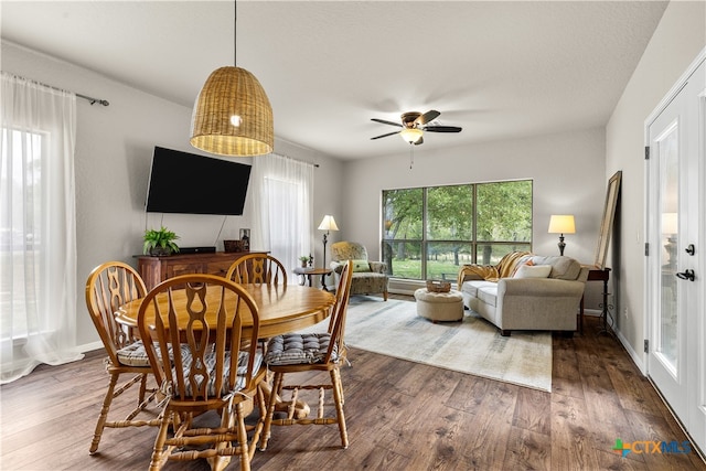 dining room with ceiling fan and dark hardwood / wood-style floors