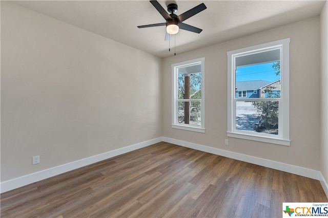 spare room featuring hardwood / wood-style floors and ceiling fan