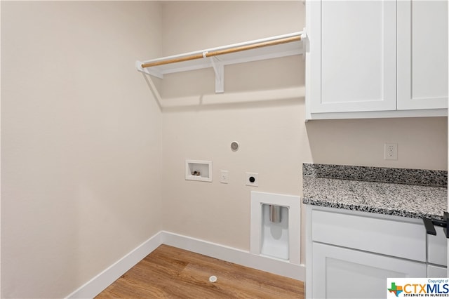 laundry room featuring cabinets, hookup for a washing machine, light wood-type flooring, and electric dryer hookup