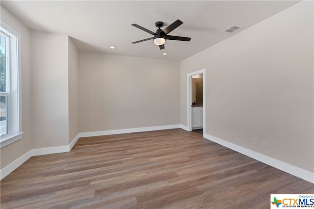 spare room with wood-type flooring and ceiling fan