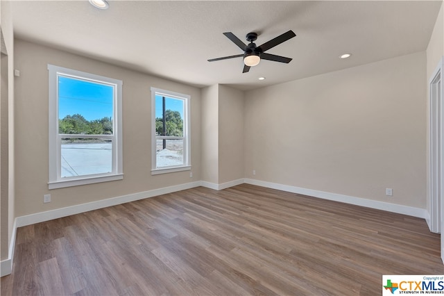 spare room featuring ceiling fan and wood-type flooring