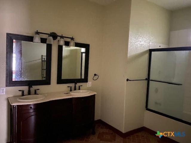 409 E Hochheim St, Yoakum, TX 77995 - bathroom with double vanity and shower / bath combination with glass door