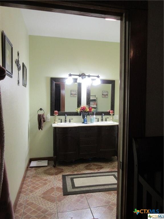 409 E Hochheim St, Yoakum, TX 77995 - bathroom with double vanity and tile patterned flooring