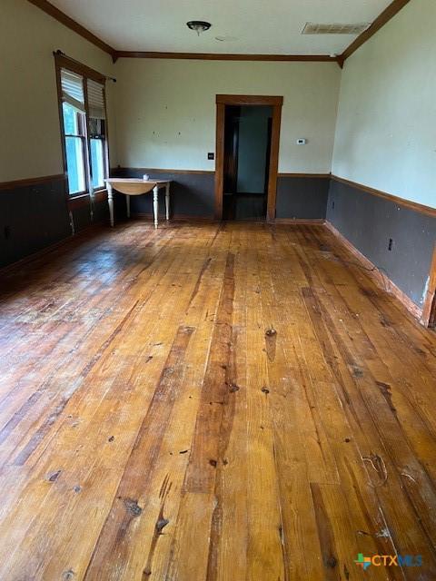 409 E Hochheim St, Yoakum, TX 77995 - unfurnished room with crown molding and wood-type flooring
