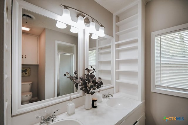 bathroom with a sink, plenty of natural light, and a stall shower