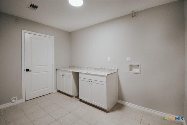 laundry area featuring light tile patterned floors, visible vents, baseboards, cabinet space, and washer hookup