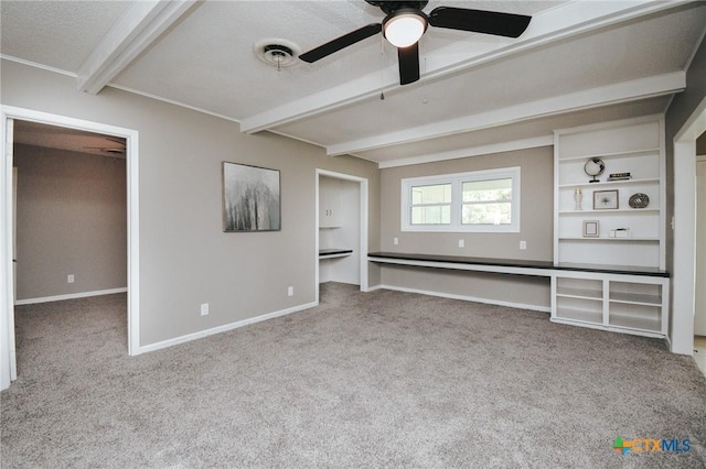 interior space featuring beam ceiling, visible vents, baseboards, and carpet