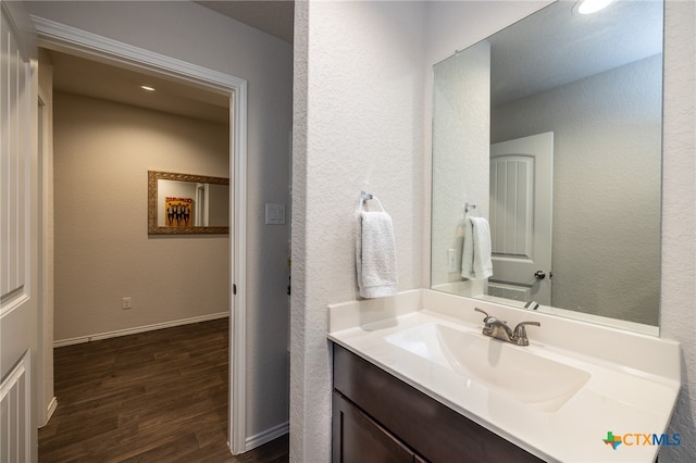 bathroom with vanity and wood-type flooring