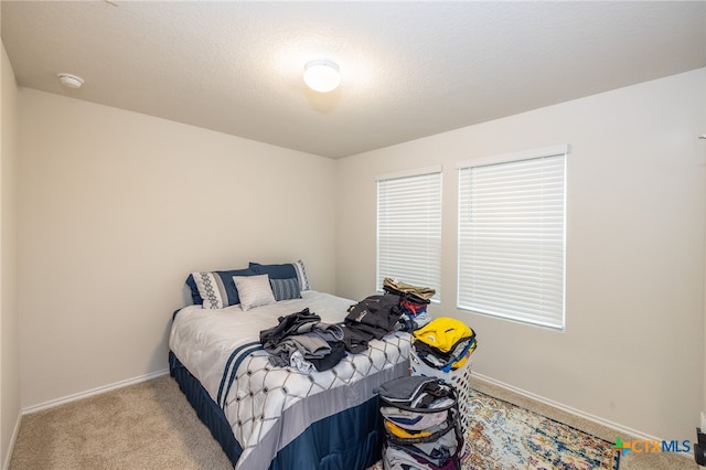 carpeted bedroom featuring a textured ceiling