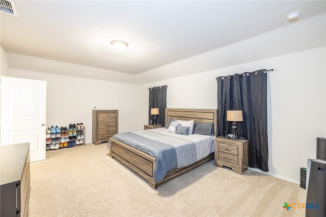 bedroom featuring light colored carpet