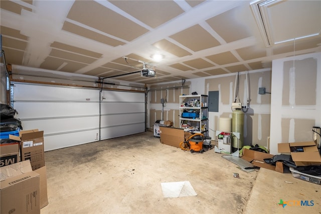 garage with electric panel and a garage door opener