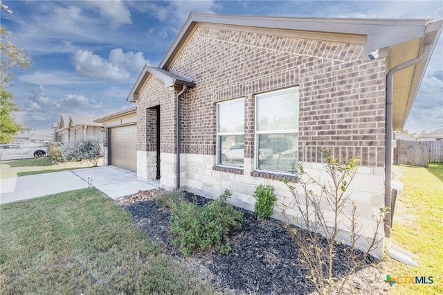 view of home's exterior with a yard and a garage