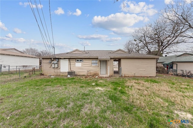 rear view of property with cooling unit and a lawn