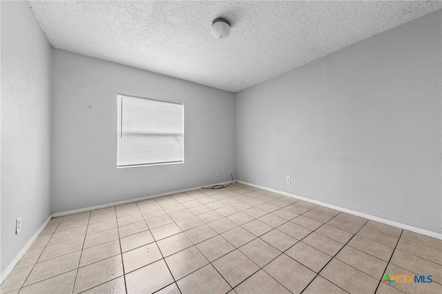 spare room with a textured ceiling