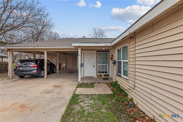 entrance to property featuring a carport