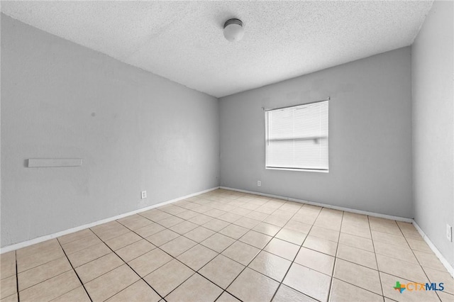 spare room featuring a textured ceiling