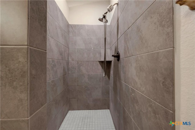 interior details featuring tiled shower