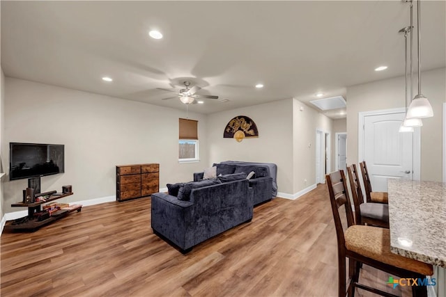 living room with hardwood / wood-style floors and ceiling fan