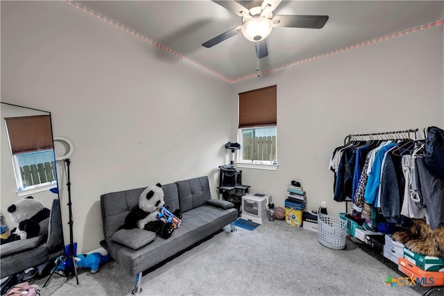 carpeted living room with ceiling fan