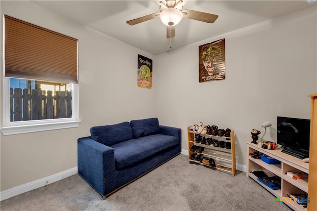 living area featuring carpet and ceiling fan