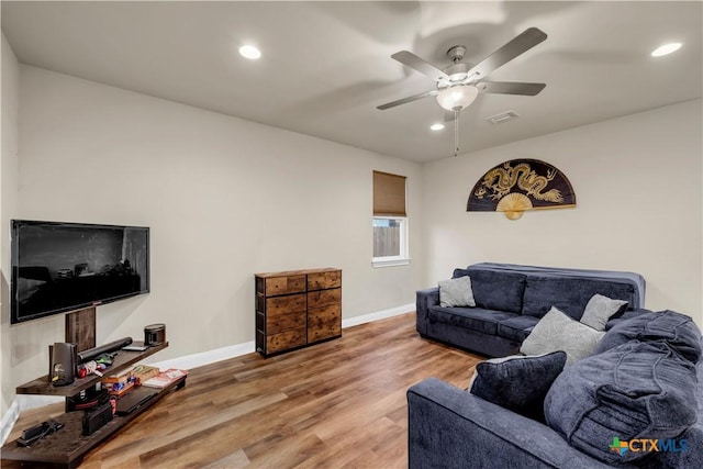 living room featuring hardwood / wood-style flooring and ceiling fan