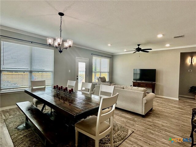 7709 Purvis St, Temple, TX 76502 - dining room featuring wood finished floors, a chandelier, ornamental molding, baseboards, and ceiling fan