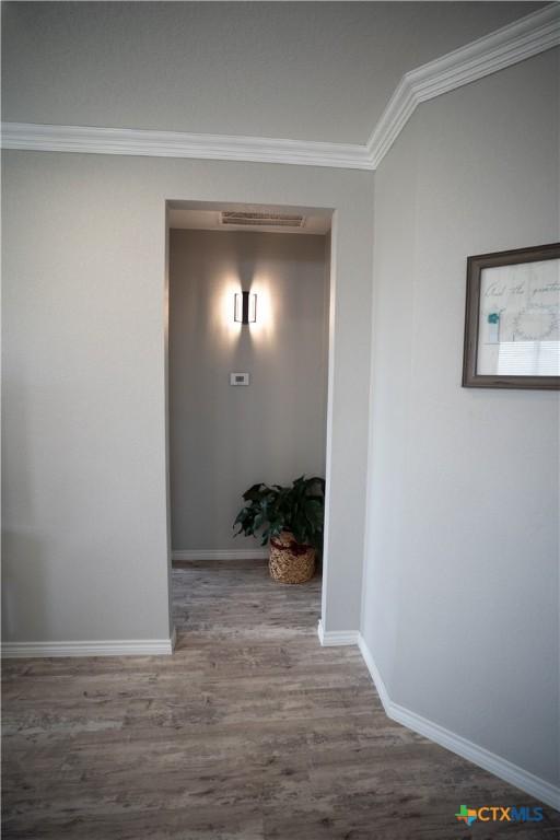 7709 Purvis St, Temple, TX 76502 - hall with ornamental molding, wood finished floors, and baseboards